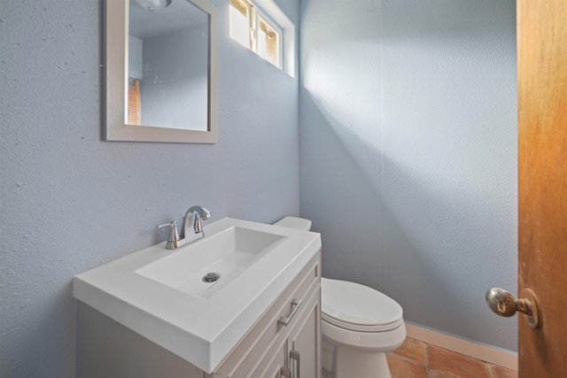 bathroom with tile patterned floors, vanity, and toilet