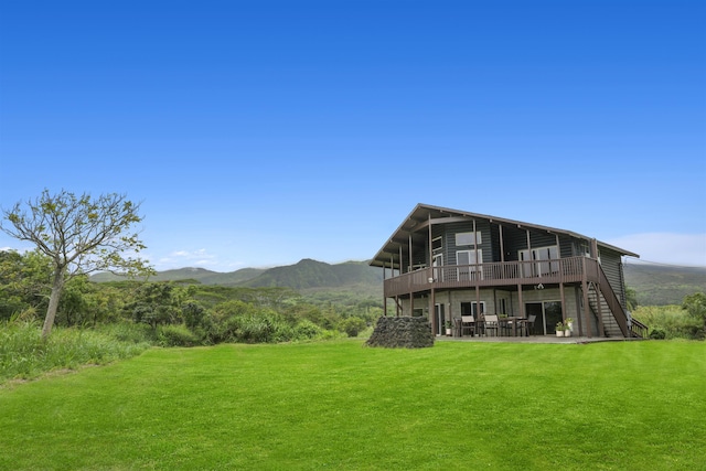 exterior space with a yard and a deck with mountain view