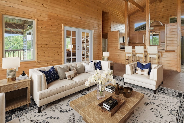 living room featuring beam ceiling, wooden walls, tile patterned flooring, and high vaulted ceiling