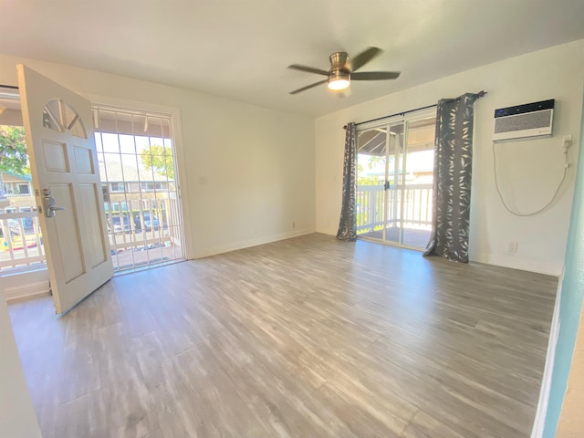 480 Kenolio Rd Unit 23-202, Kihei, HI 96753 - unfurnished room featuring ceiling fan, light wood finished floors, and a wall mounted AC