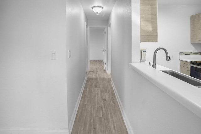 480 Kenolio Rd Unit 23-202, Kihei, HI 96753 - hall featuring light wood-style floors and a sink