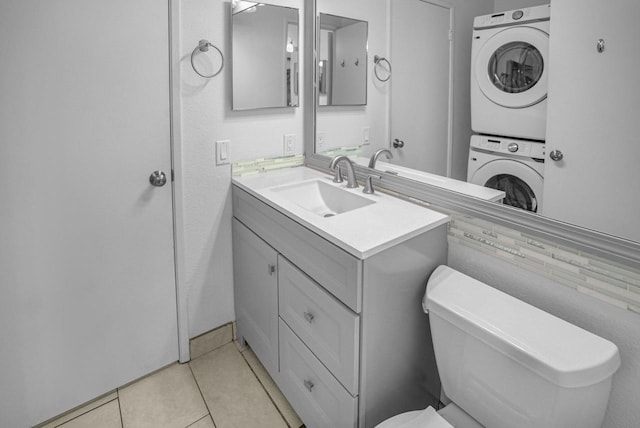 480 Kenolio Rd Unit 23-202, Kihei, HI 96753 - bathroom featuring stacked washer / drying machine, vanity, and tile patterned floors