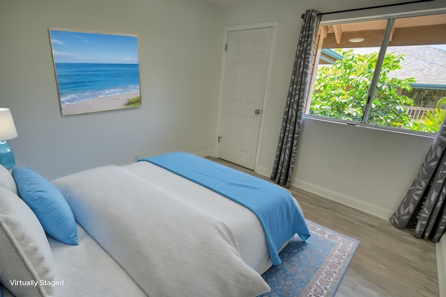 480 Kenolio Rd Unit 23-202, Kihei, HI 96753 - bedroom featuring wood finished floors and baseboards