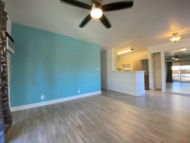 480 Kenolio Rd Unit 23-202, Kihei, HI 96753 - unfurnished living room featuring ceiling fan and light wood-style floors