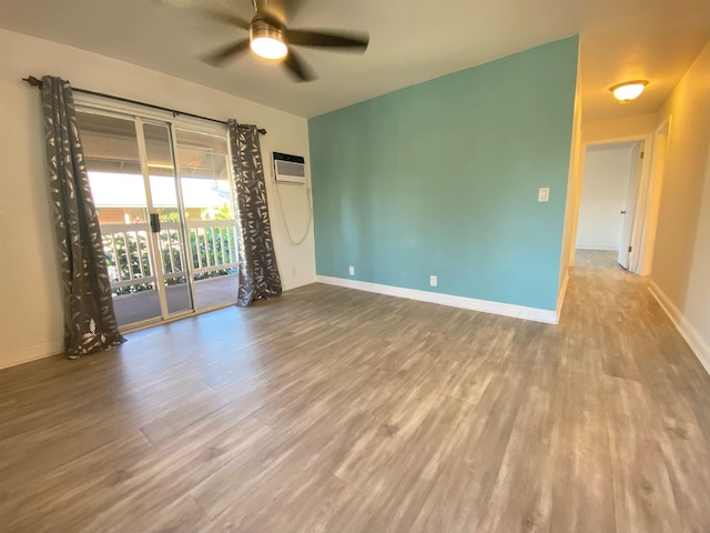 480 Kenolio Rd Unit 23-202, Kihei, HI 96753 - spare room featuring ceiling fan, wood finished floors, and a wall unit AC