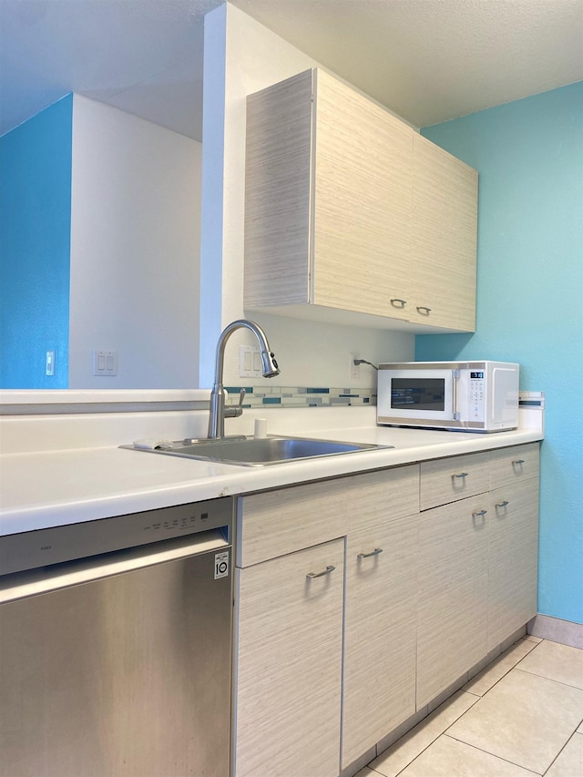 480 Kenolio Rd Unit 23-202, Kihei, HI 96753 - kitchen with stainless steel dishwasher, white microwave, light countertops, and light tile patterned floors