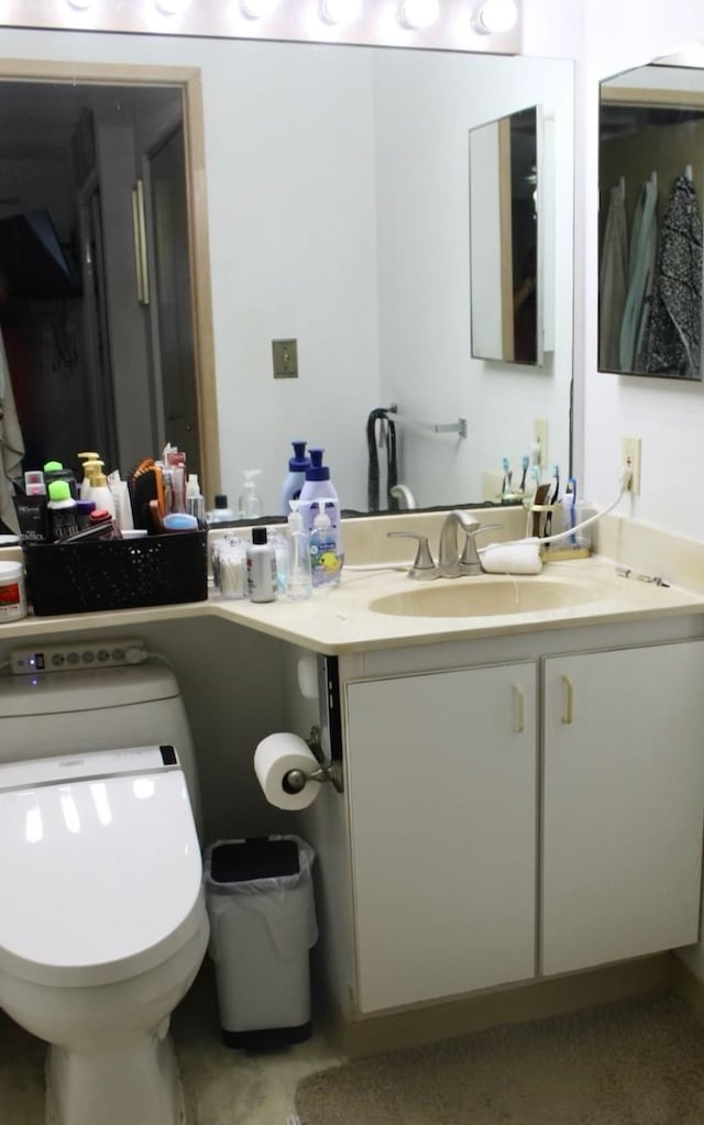 bathroom featuring toilet and vanity