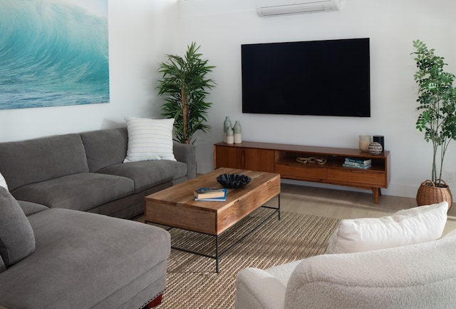 living room featuring baseboards and a wall unit AC
