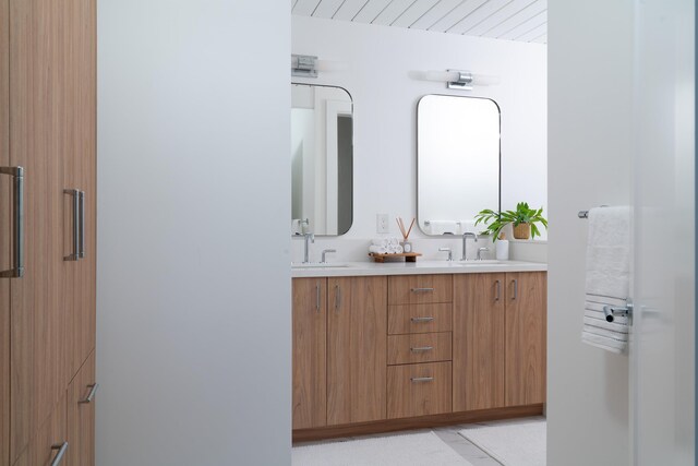 full bath featuring double vanity and a sink