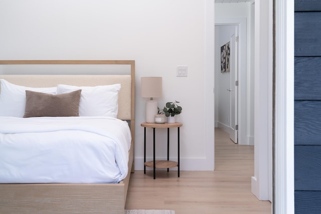 bedroom featuring baseboards and wood finished floors