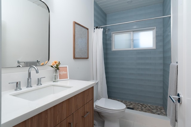 full bath with a shower stall, vanity, and toilet
