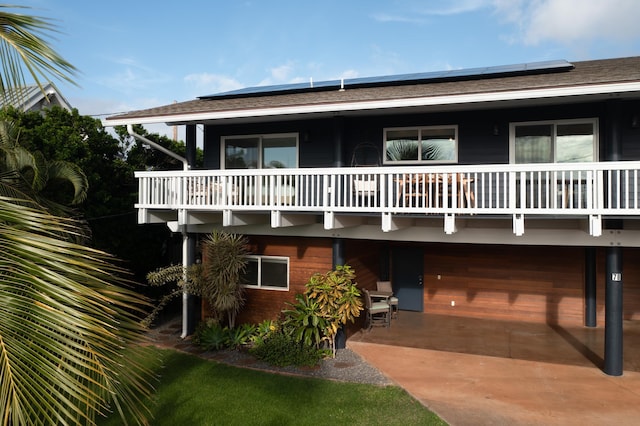 view of front facade with roof mounted solar panels
