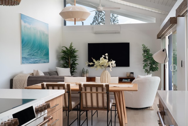 dining space featuring an AC wall unit, light wood-style floors, and lofted ceiling