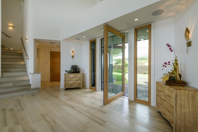 entryway featuring a wall of windows and light wood-type flooring