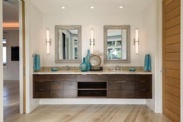 bathroom featuring hardwood / wood-style floors and dual bowl vanity