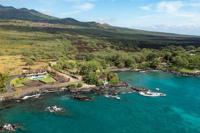 birds eye view of property with a water and mountain view