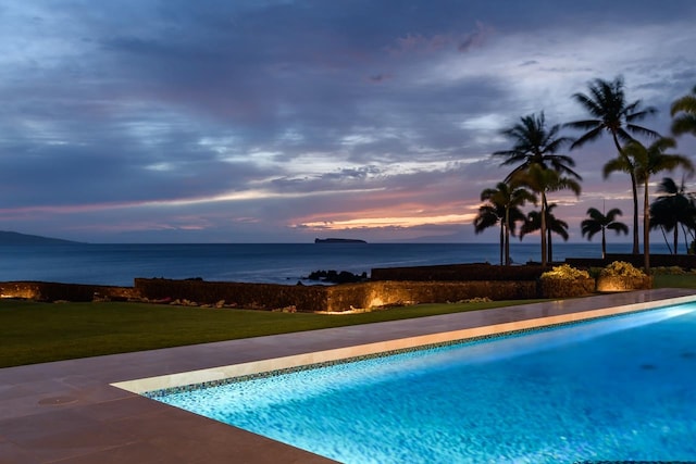 pool at dusk with a yard