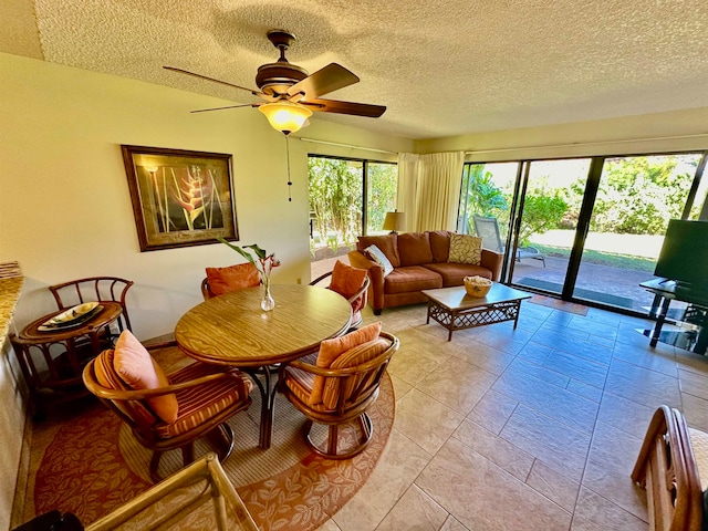 tiled living room with a textured ceiling and ceiling fan