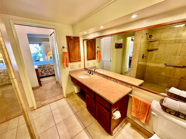 bathroom featuring tile floors, toilet, a shower with door, and vanity