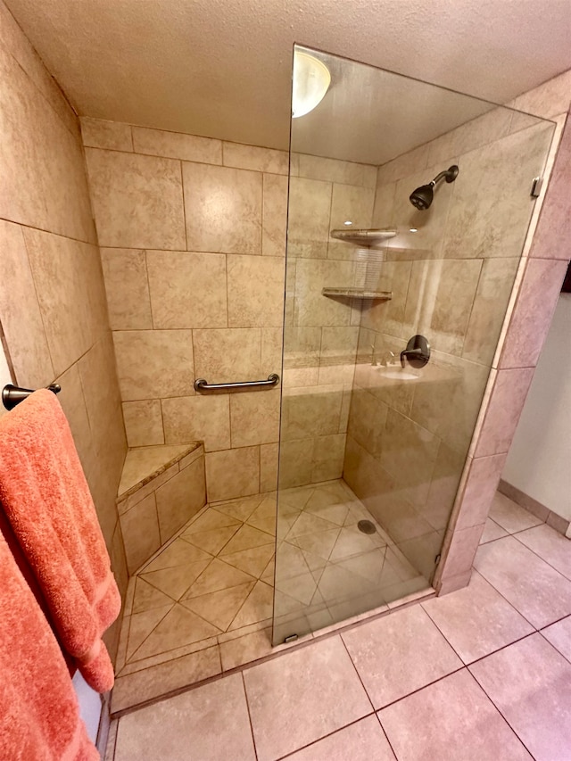 bathroom featuring walk in shower and a textured ceiling