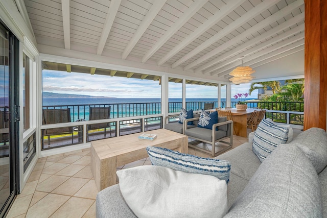 sunroom with lofted ceiling with beams, a water view, and wooden ceiling