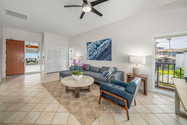 tiled living room with ceiling fan