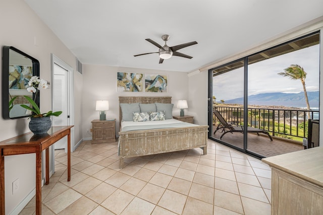 tiled bedroom featuring access to outside, a mountain view, and ceiling fan