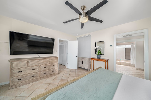 tiled bedroom featuring ceiling fan and ensuite bathroom