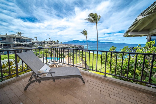 balcony featuring a water and mountain view