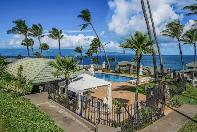 view of swimming pool featuring a water view and a patio