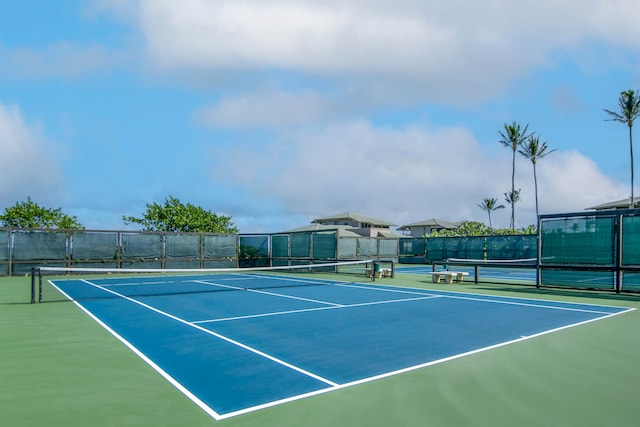 view of tennis court featuring basketball hoop