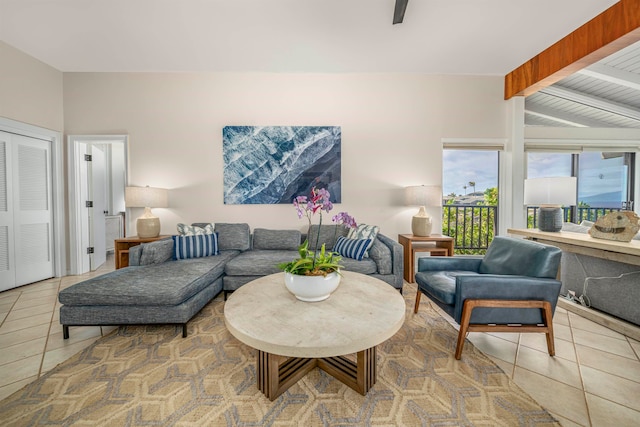 living room with light tile patterned floors and lofted ceiling with beams