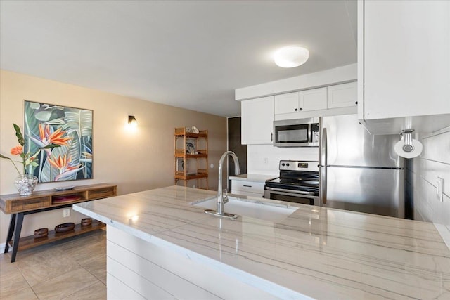 2737 S Kihei Rd Unit 160, Kihei, HI 96753 - kitchen with appliances with stainless steel finishes, a sink, white cabinetry, and light stone counters