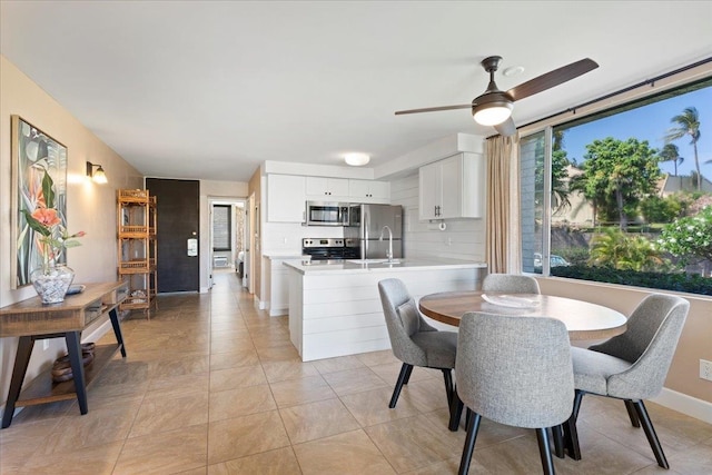 tiled dining area featuring ceiling fan