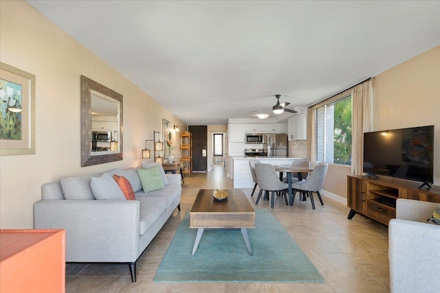 living room featuring ceiling fan and light tile patterned floors