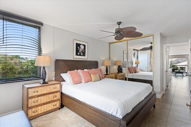 bedroom featuring light tile patterned floors, a closet, and ceiling fan