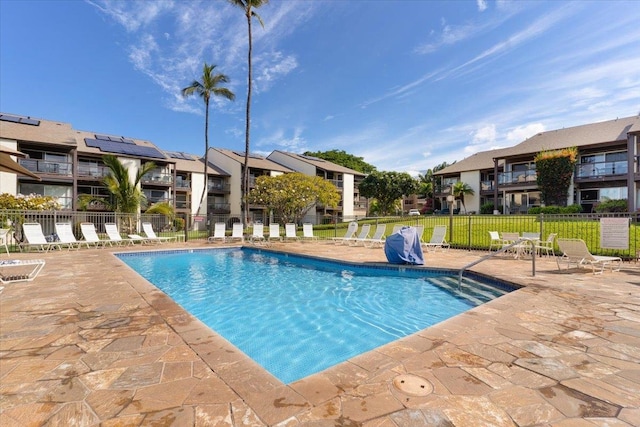 view of swimming pool featuring a lawn and a patio