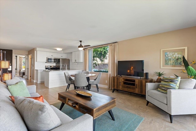 living room featuring ceiling fan, a healthy amount of sunlight, and light tile patterned flooring