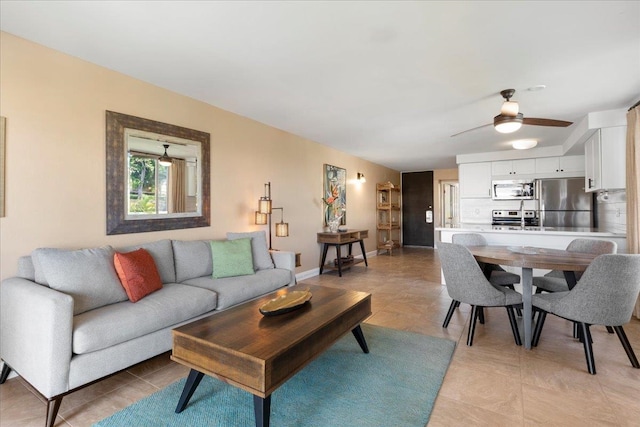 living room with light tile patterned floors and ceiling fan