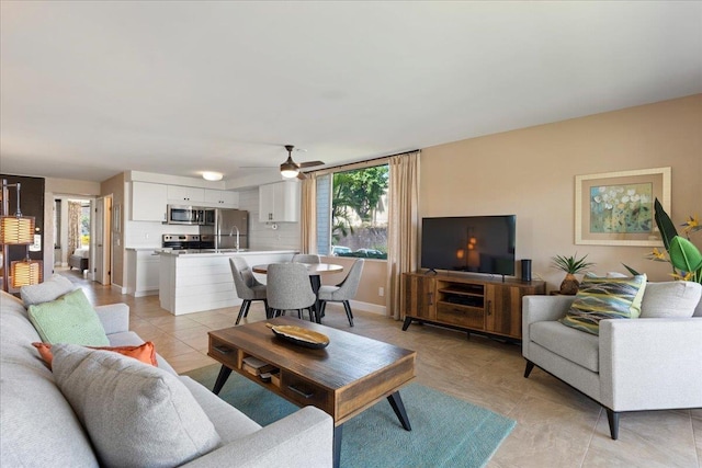 2737 S Kihei Rd Unit 160, Kihei, HI 96753 - living area featuring light tile patterned floors, a ceiling fan, and baseboards