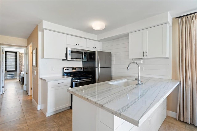 2737 S Kihei Rd Unit 160, Kihei, HI 96753 - kitchen featuring appliances with stainless steel finishes, a sink, a peninsula, white cabinets, and light tile patterned floors