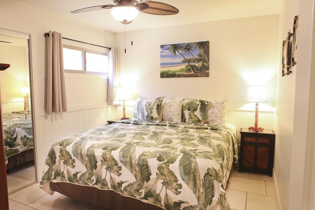 115 N Kihei Rd Unit A3, Kihei, HI 96753 - bedroom featuring light tile patterned flooring, a wainscoted wall, and a ceiling fan