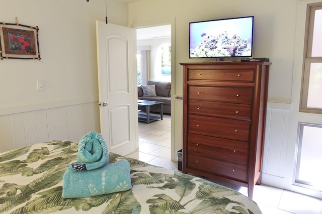 115 N Kihei Rd Unit A3, Kihei, HI 96753 - bedroom featuring light tile patterned floors and a wainscoted wall