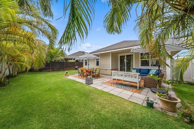 rear view of property featuring a patio area, outdoor lounge area, and a lawn