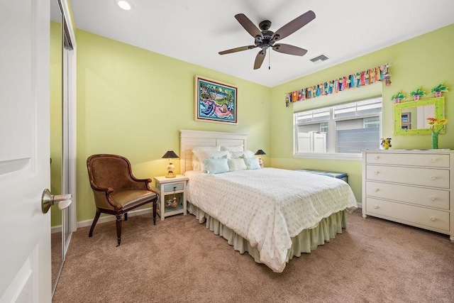 carpeted bedroom featuring ceiling fan and a closet