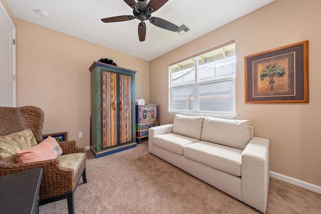 carpeted living room featuring ceiling fan