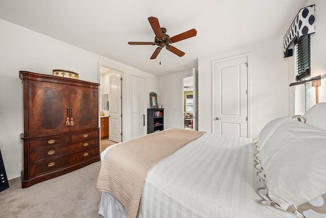 carpeted bedroom with ceiling fan and connected bathroom