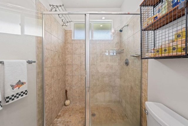 bathroom featuring an enclosed shower and toilet