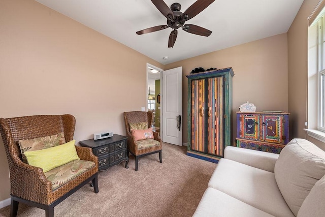 bedroom with light carpet, ceiling fan, and a closet