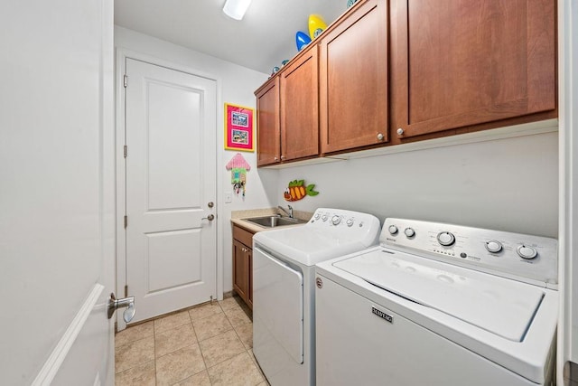 washroom featuring light tile patterned floors, ceiling fan, washer and dryer, cabinets, and sink